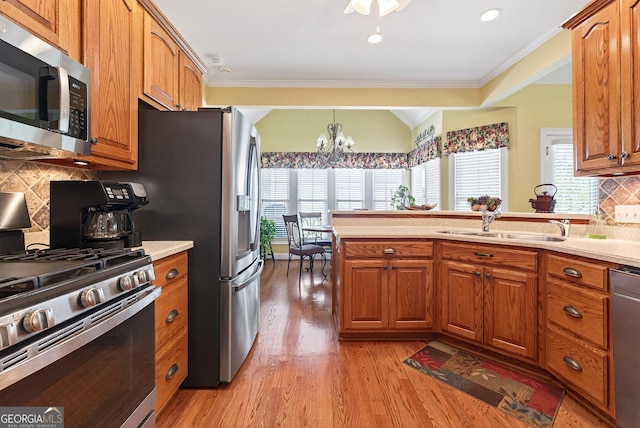 865 Laurel Ridge Rd, Cleveland, GA 30528 - kitchen with appliances with stainless steel finishes, ornamental molding, a chandelier, healthy amount of natural light, and brown cabinets