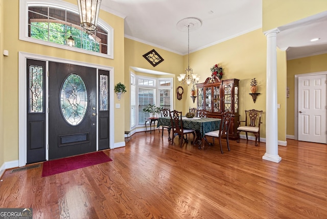 865 Laurel Ridge Rd, Cleveland, GA 30528 - foyer entrance featuring wood finished floors, ornamental molding, ornate columns, a chandelier, and a towering ceiling