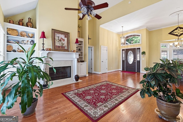 865 Laurel Ridge Rd, Cleveland, GA 30528 - foyer entrance with a towering ceiling, ceiling fan, a chandelier, wood finished floors, and crown molding