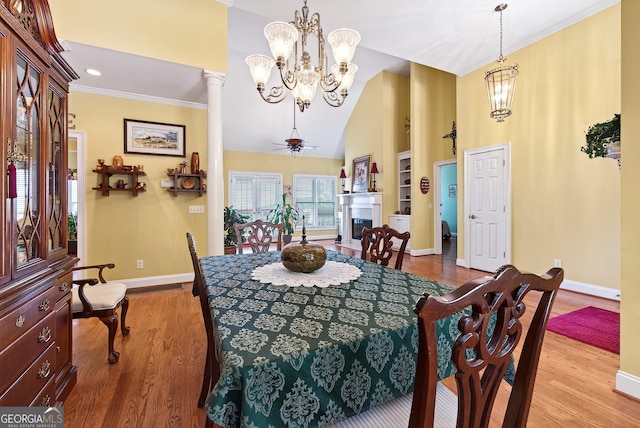 865 Laurel Ridge Rd, Cleveland, GA 30528 - dining area with a chandelier, light wood-style floors, high vaulted ceiling, ornamental molding, and a fireplace