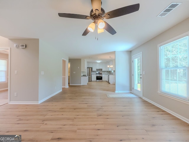 1904 Watercrest Cir, Lawrenceville, GA 30043 - unfurnished living room with light wood finished floors and ceiling fan