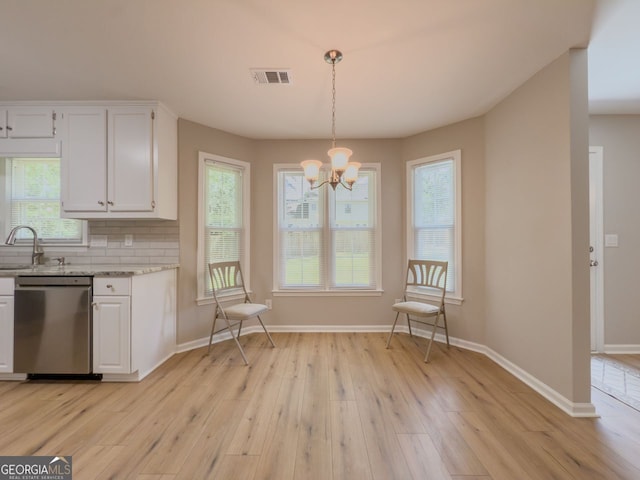 1904 Watercrest Cir, Lawrenceville, GA 30043 - kitchen featuring dishwasher, white cabinetry, a chandelier, light wood-style flooring, and backsplash