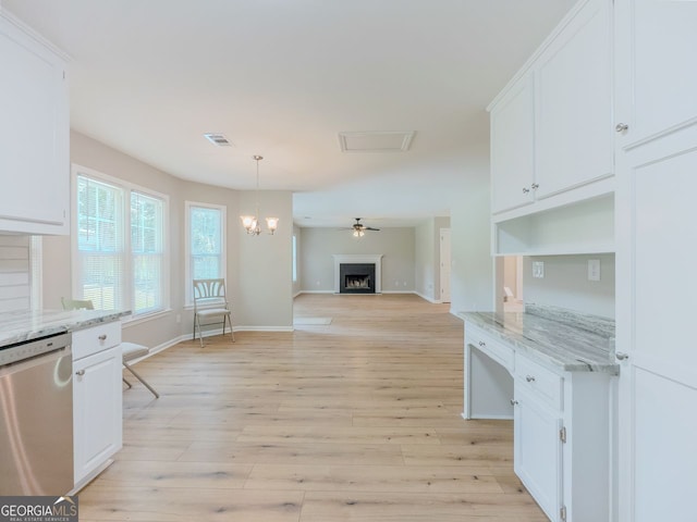 1904 Watercrest Cir, Lawrenceville, GA 30043 - kitchen featuring stainless steel dishwasher, white cabinets, light stone countertops, hanging light fixtures, and light wood-style floors
