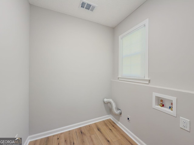 1904 Watercrest Cir, Lawrenceville, GA 30043 - laundry area featuring electric dryer hookup, wood finished floors, and hookup for a washing machine