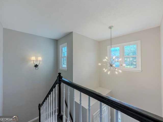 1904 Watercrest Cir, Lawrenceville, GA 30043 - hall with an upstairs landing, plenty of natural light, and a chandelier