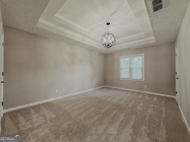 1904 Watercrest Cir, Lawrenceville, GA 30043 - spare room featuring a tray ceiling, carpet flooring, a chandelier, crown molding, and a textured ceiling