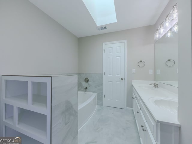 1904 Watercrest Cir, Lawrenceville, GA 30043 - bathroom with a skylight, marble look tile flooring, double vanity, and a bath