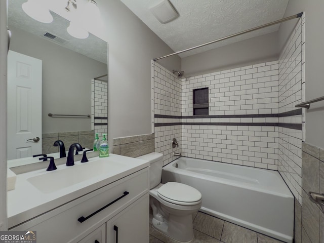 1904 Watercrest Cir, Lawrenceville, GA 30043 - full bath featuring tile walls, tub / shower combination, vanity, a textured ceiling, and tile patterned floors