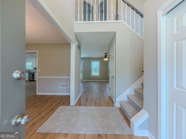 1904 Watercrest Cir, Lawrenceville, GA 30043 - foyer entrance featuring wood finished floors, stairway, and a ceiling fan