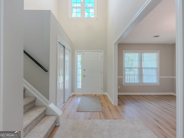1904 Watercrest Cir, Lawrenceville, GA 30043 - foyer featuring wood finished floors, stairs, and a towering ceiling