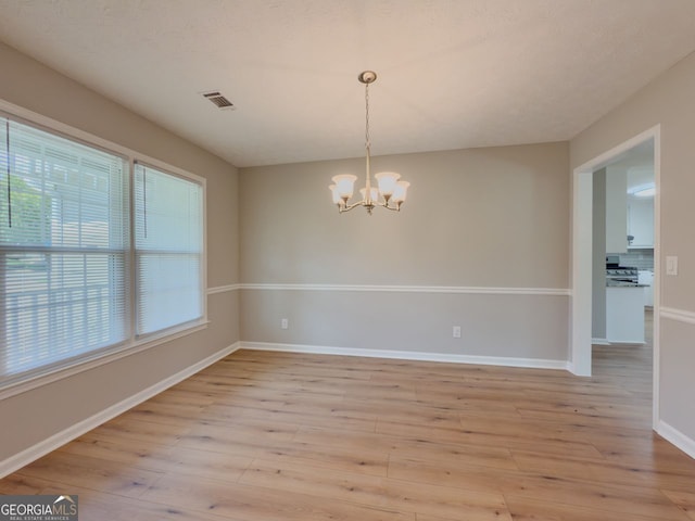 1904 Watercrest Cir, Lawrenceville, GA 30043 - empty room with a chandelier and light wood-style floors