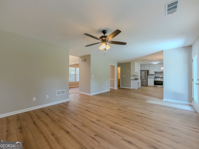 1904 Watercrest Cir, Lawrenceville, GA 30043 - unfurnished living room featuring a ceiling fan and light wood-style flooring