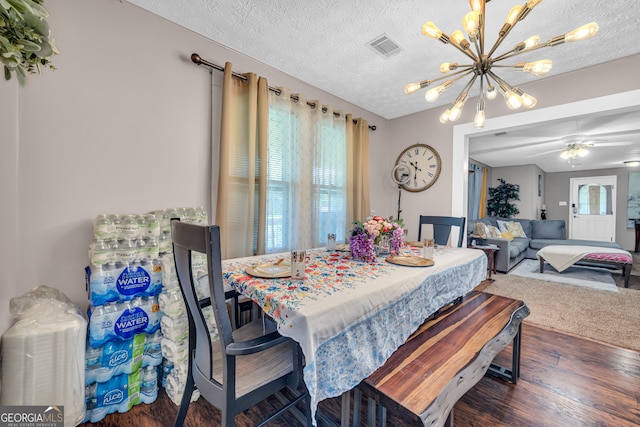 116 Rickman St, Toccoa, GA 30577 - dining area featuring a chandelier, wood finished floors, and a textured ceiling