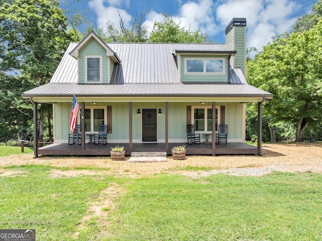 2092 Pleasant Hill Rd NE, Ranger, GA 30734 - view of front facade featuring board and batten siding, a porch, a front lawn, and a chimney