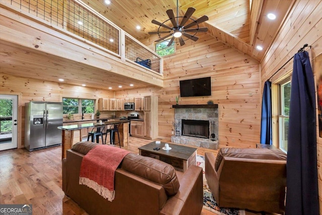2092 Pleasant Hill Rd NE, Ranger, GA 30734 - living area featuring wooden ceiling, wood walls, high vaulted ceiling, a ceiling fan, and a fireplace