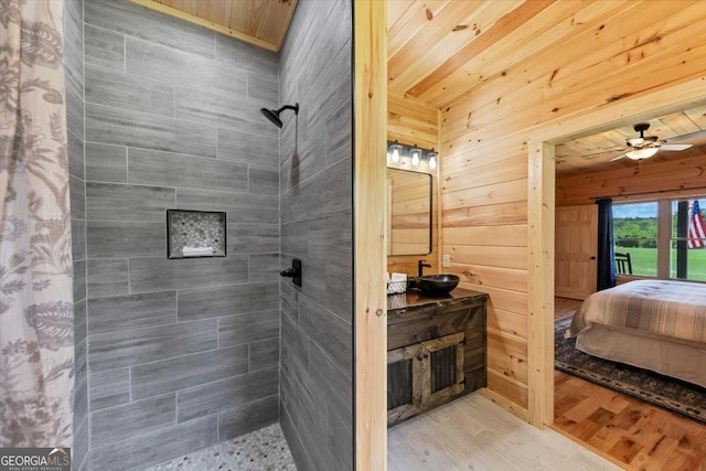 2092 Pleasant Hill Rd NE, Ranger, GA 30734 - ensuite bathroom featuring a tile shower, vanity, wood finished floors, a ceiling fan, and wooden walls