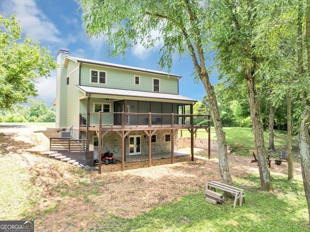 2092 Pleasant Hill Rd NE, Ranger, GA 30734 - back of property with a chimney, a deck, stone siding, a metal roof, and a patio