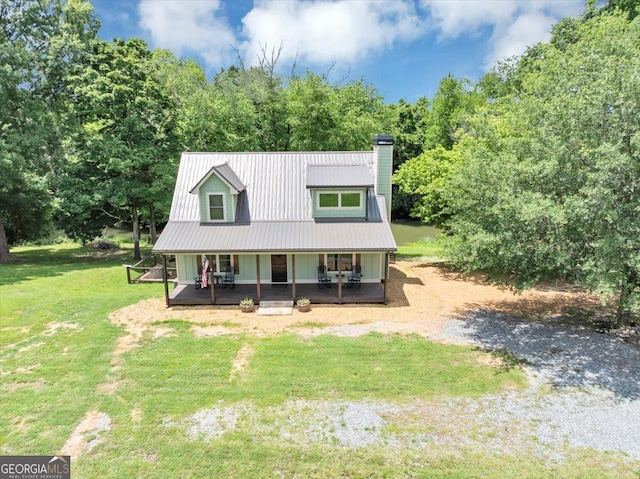 2092 Pleasant Hill Rd NE, Ranger, GA 30734 - view of front of house with covered porch, a chimney, a front lawn, and a metal roof