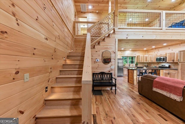 2092 Pleasant Hill Rd NE, Ranger, GA 30734 - stairs with wood walls, hardwood / wood-style flooring, and a high ceiling