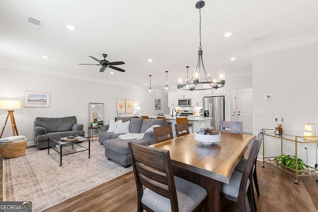 1316 Willamette Way, Marietta, GA 30008 - dining space featuring dark wood-style flooring, ceiling fan, recessed lighting, a chandelier, and ornamental molding
