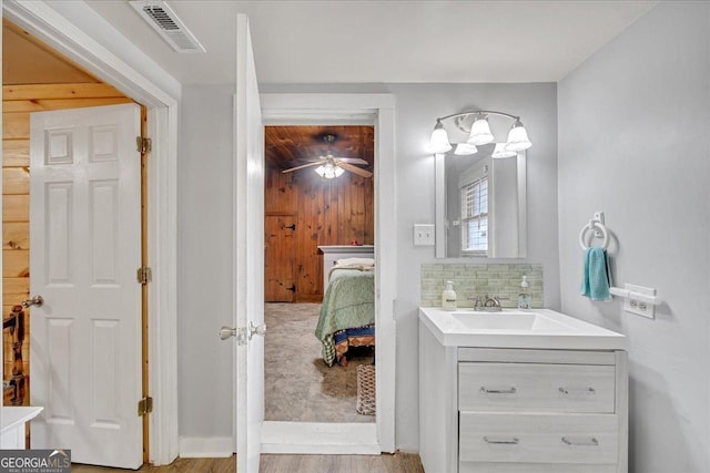 4253 Swallows Creek Rd, Hiawassee, GA 30546 - ensuite bathroom featuring vanity, wood finished floors, decorative backsplash, and a ceiling fan