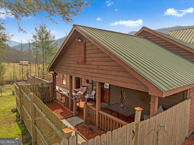 4253 Swallows Creek Rd, Hiawassee, GA 30546 - view of home's exterior with a metal roof, a porch, a mountain view, and a standing seam roof