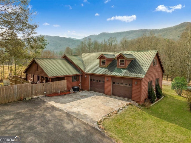4253 Swallows Creek Rd, Hiawassee, GA 30546 - rustic home with driveway, a mountain view, an attached garage, and a metal roof