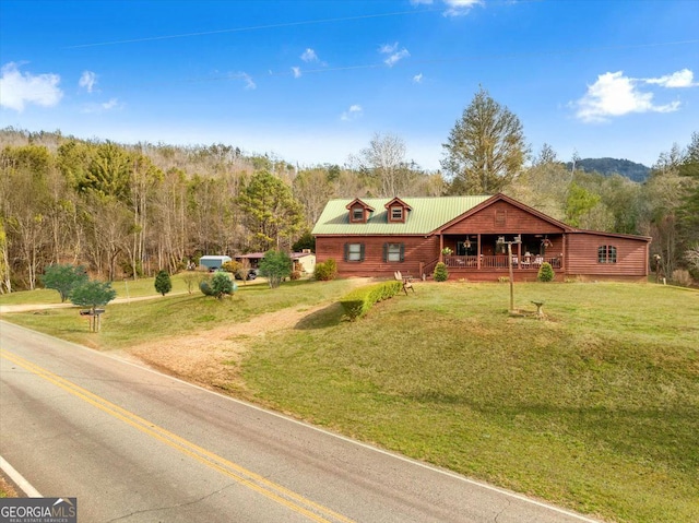 4253 Swallows Creek Rd, Hiawassee, GA 30546 - view of front of house with a porch, a front lawn, and a wooded view