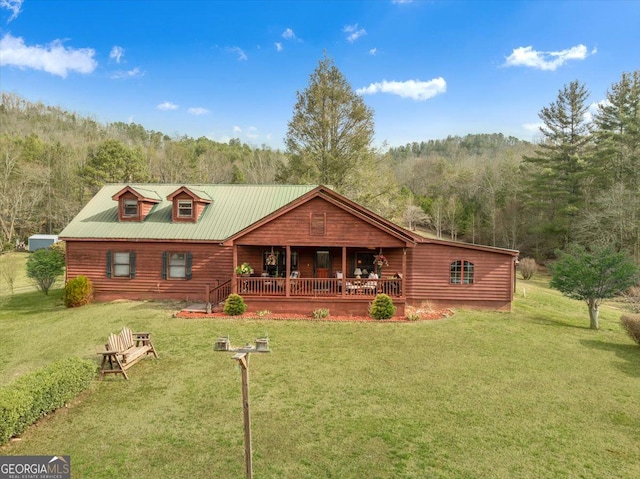 4253 Swallows Creek Rd, Hiawassee, GA 30546 - back of property with covered porch, a yard, a forest view, and a metal roof