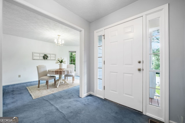 3 Maplelake Dr, Acworth, GA 30101 - entryway featuring dark colored carpet, a chandelier, and a textured ceiling
