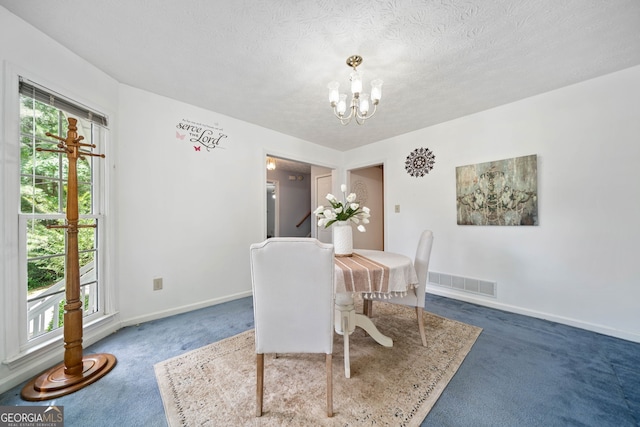 3 Maplelake Dr, Acworth, GA 30101 - carpeted dining space with healthy amount of natural light, a chandelier, and a textured ceiling