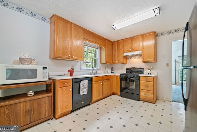 3 Maplelake Dr, Acworth, GA 30101 - kitchen with black appliances, under cabinet range hood, light countertops, a textured ceiling, and light floors