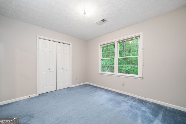 3 Maplelake Dr, Acworth, GA 30101 - unfurnished bedroom with carpet flooring, a closet, and a textured ceiling