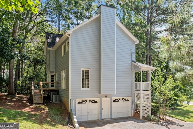 3 Maplelake Dr, Acworth, GA 30101 - view of property exterior featuring an attached garage, concrete driveway, a chimney, stairway, and a wooden deck