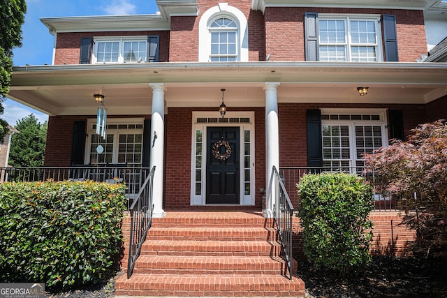 351 Prestbury Ct, Suwanee, GA 30024 - doorway to property with brick siding and a porch