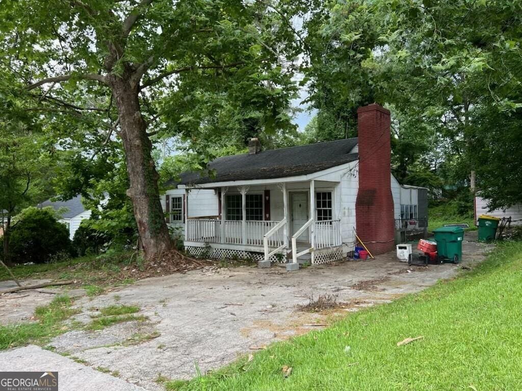 766 Warren Dr, Riverdale, GA 30296 - view of front of house featuring a chimney and covered porch