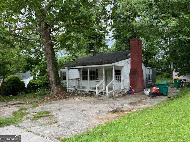 766 Warren Dr, Riverdale, GA 30296 - view of front of house featuring a chimney and covered porch