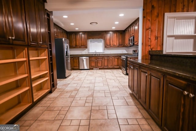 500 Holmes St, Barnesville, GA 30204 - kitchen with stainless steel appliances, recessed lighting, open shelves, dark brown cabinetry, and dark stone countertops