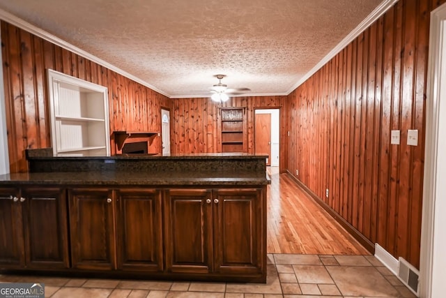 500 Holmes St, Barnesville, GA 30204 - bar with ornamental molding, wood walls, ceiling fan, a textured ceiling, and light tile patterned flooring