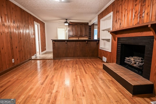 500 Holmes St, Barnesville, GA 30204 - kitchen with stainless steel fridge with ice dispenser, ornamental molding, a ceiling fan, a breakfast bar, and light wood-style flooring