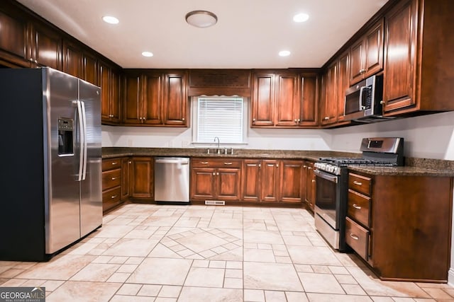 500 Holmes St, Barnesville, GA 30204 - kitchen with stainless steel appliances, recessed lighting, dark stone countertops, and light tile patterned flooring