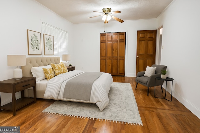 500 Holmes St, Barnesville, GA 30204 - bedroom featuring a closet, ornamental molding, wood finished floors, and a ceiling fan