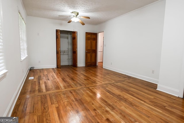 500 Holmes St, Barnesville, GA 30204 - unfurnished bedroom with hardwood / wood-style flooring, a textured ceiling, a ceiling fan, and a closet