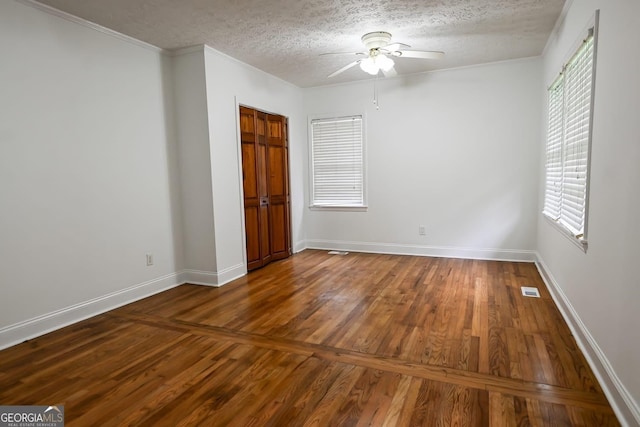 500 Holmes St, Barnesville, GA 30204 - unfurnished bedroom featuring wood finished floors, a textured ceiling, ceiling fan, and ornamental molding
