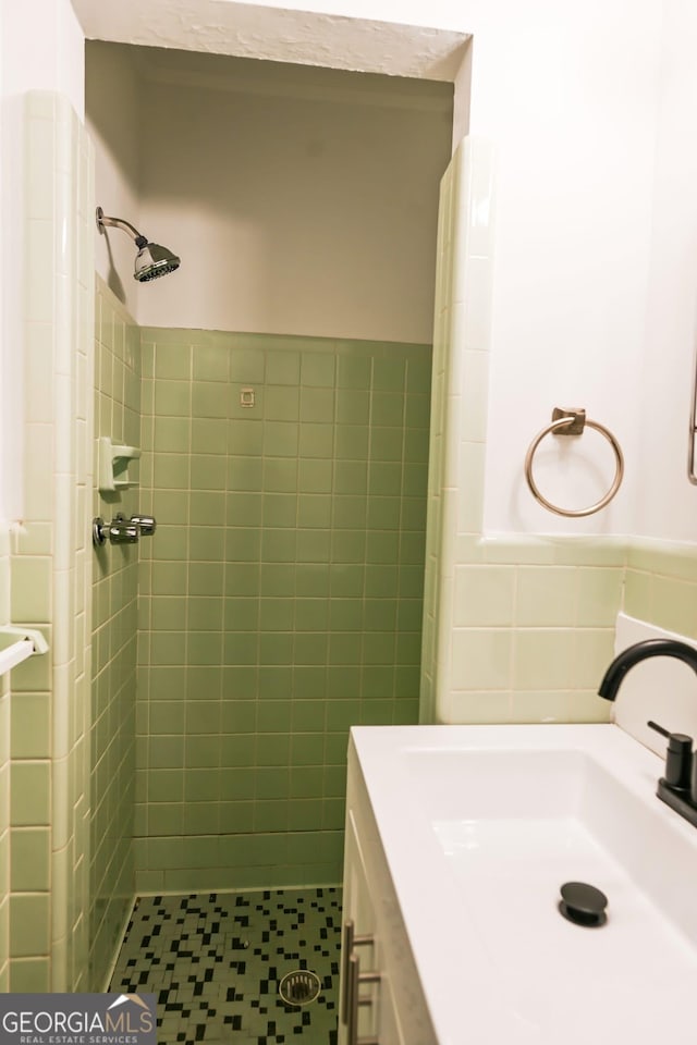 500 Holmes St, Barnesville, GA 30204 - bathroom with a stall shower, tile walls, tile patterned flooring, vanity, and a wainscoted wall