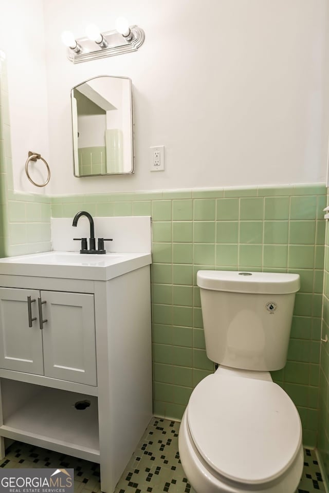 500 Holmes St, Barnesville, GA 30204 - bathroom featuring tile walls, vanity, and a wainscoted wall