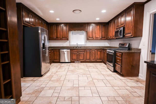 500 Holmes St, Barnesville, GA 30204 - kitchen featuring appliances with stainless steel finishes, recessed lighting, dark stone countertops, and dark brown cabinetry