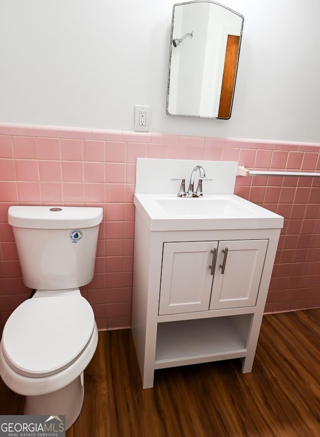 500 Holmes St, Barnesville, GA 30204 - bathroom with tile walls, wood finished floors, vanity, and a wainscoted wall