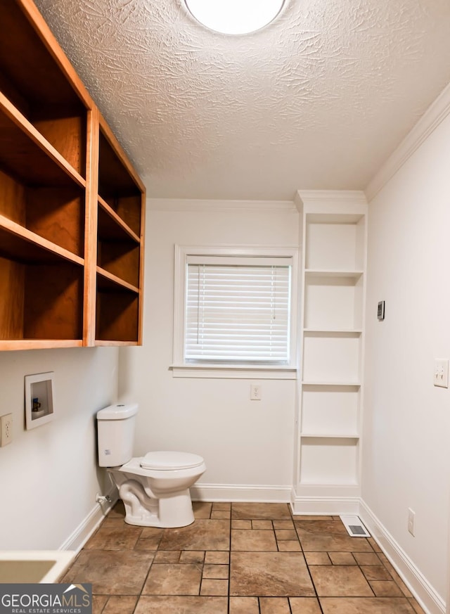 500 Holmes St, Barnesville, GA 30204 - bathroom featuring a textured ceiling, ornamental molding, and built in features