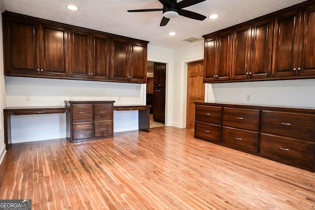 500 Holmes St, Barnesville, GA 30204 - kitchen featuring built in study area, ceiling fan, light wood-style floors, recessed lighting, and dark brown cabinetry